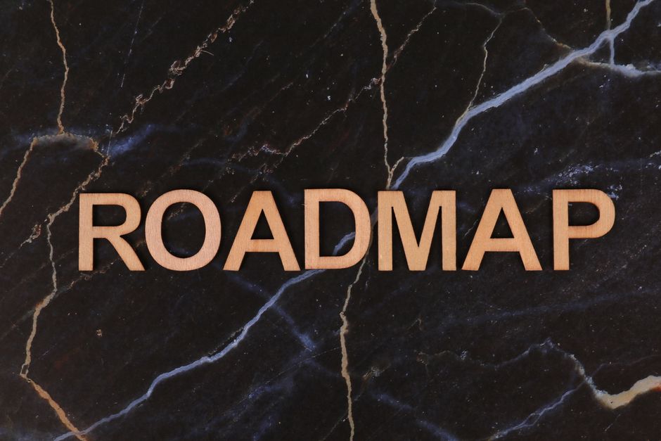 Wooden letters spelling ROADMAP on a dark marble surface, ideal for business presentations.